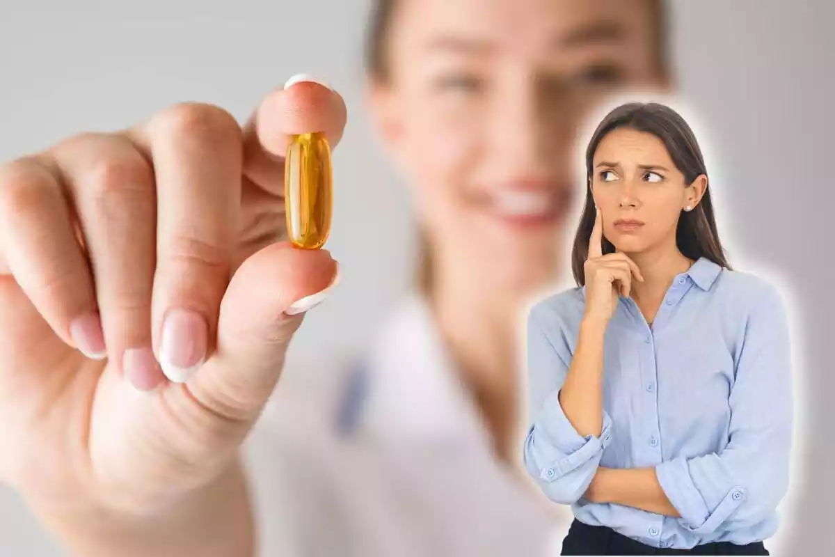Mujer preocupada mirando una pastilla de vitamina
